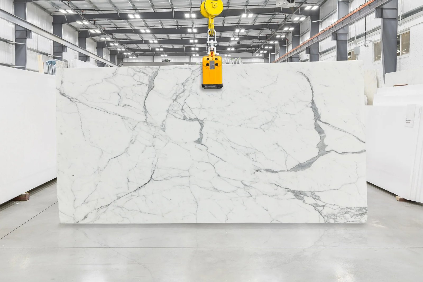 Full slab of Statuario White marble with fine grey veining inside a stone facility